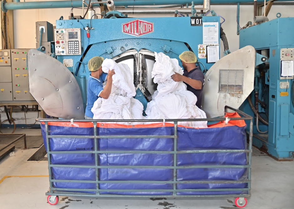 Mas Aero Staff loading clothes to Commercial Laundry Machine Mas Aero Staff loading clothes to Commercial Laundry Machine